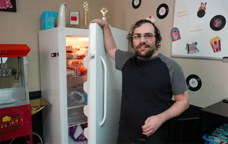 man next to a refrigerator