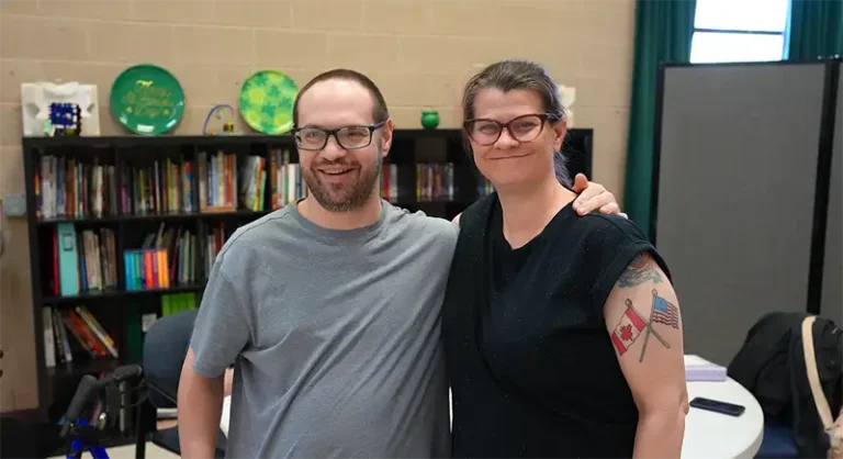 two people standing side by side