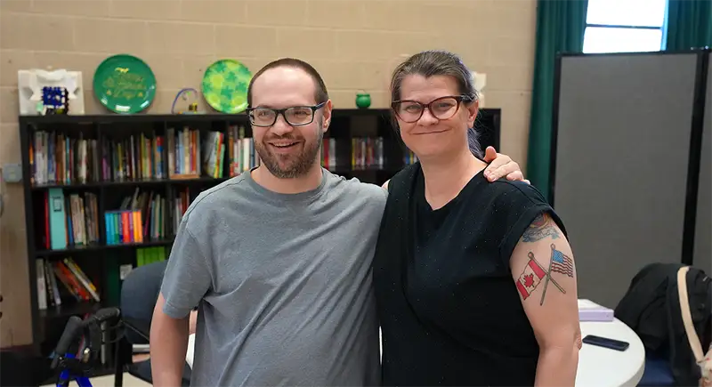two people standing side by side