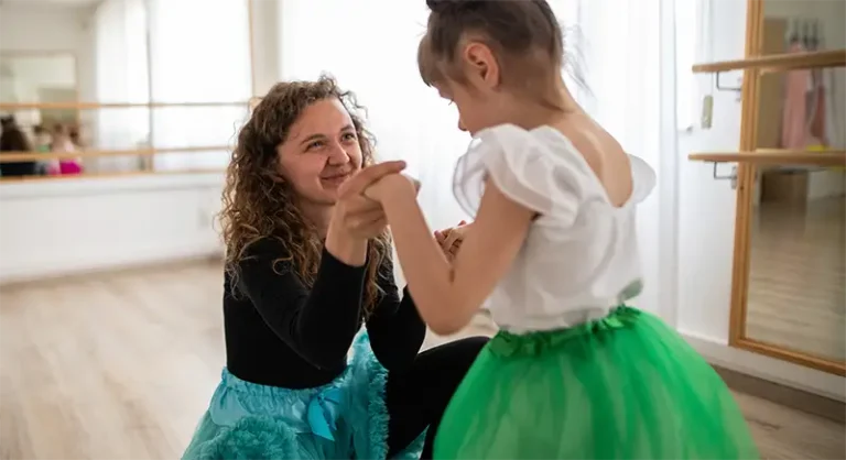 woman teaching child to dance
