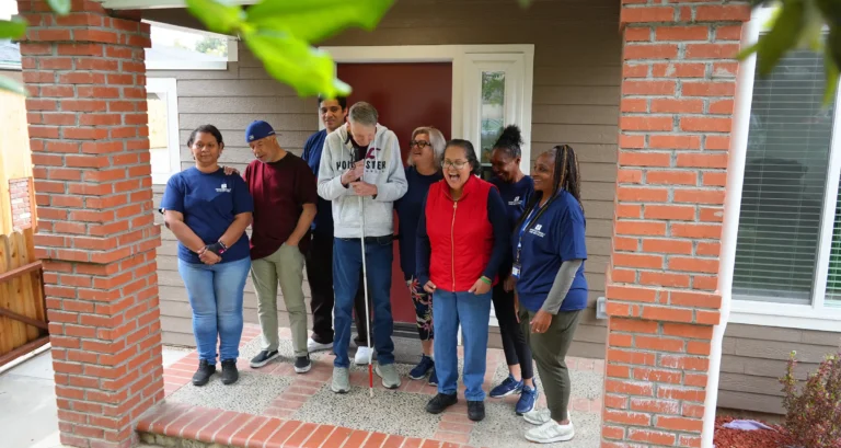 Redwood team and individuals on a porch