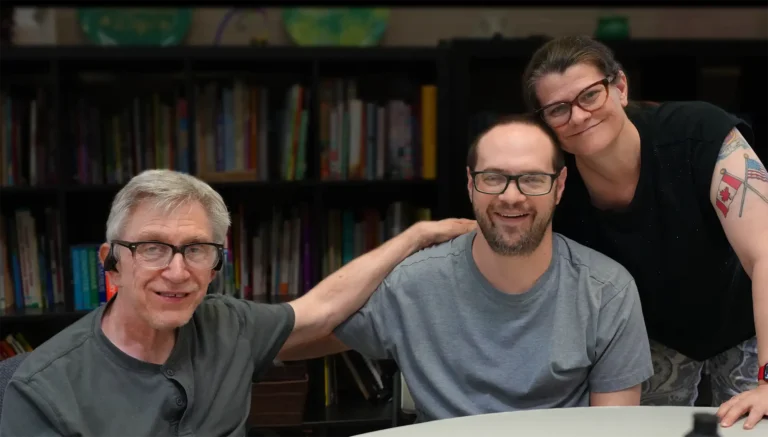 individuals in front of bookcase