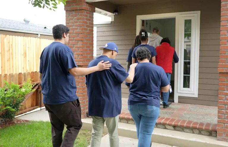 group of people walking up steps to porch