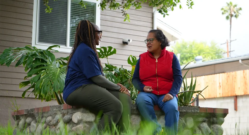 Redwood staffer speaking with individual outside