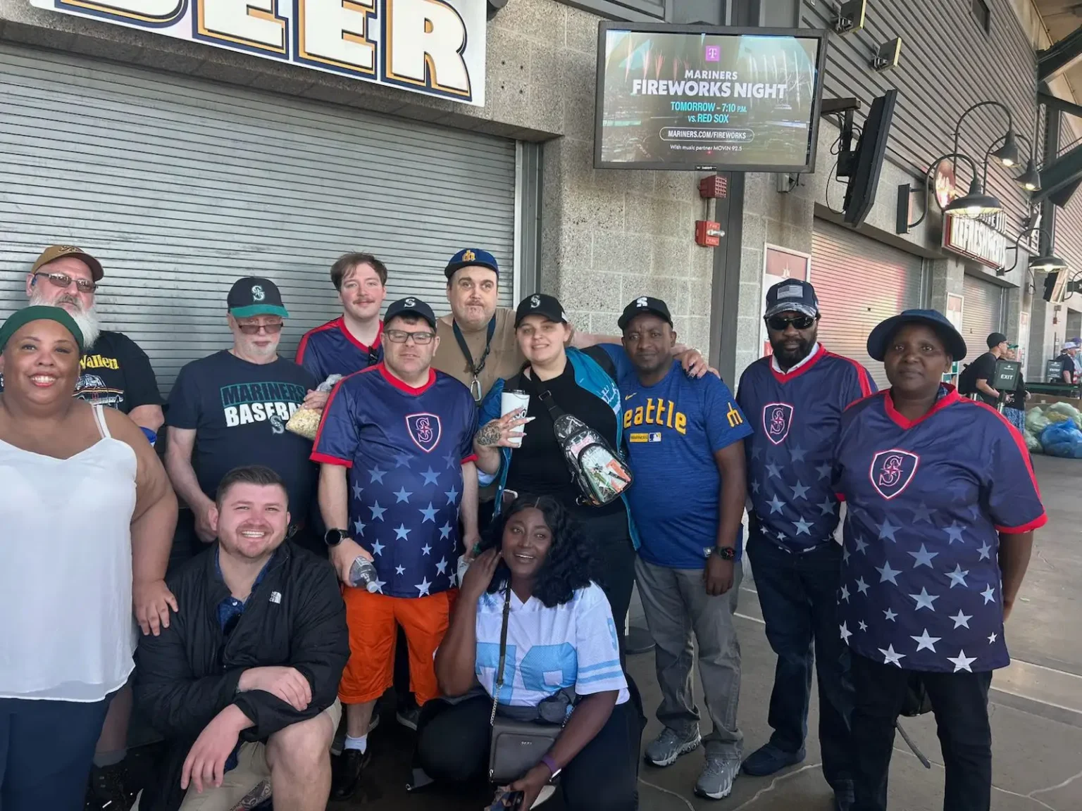Redwood staff and individuals at a baseball park