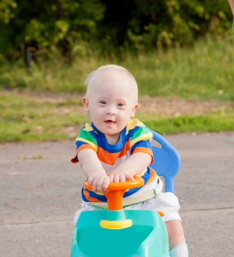 Toddler on a toy car