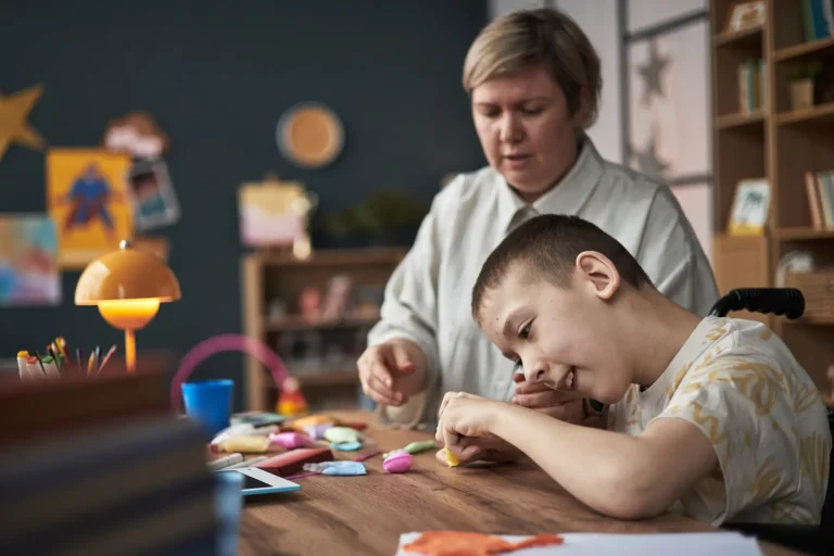 caregiver and child engaged in craft activity