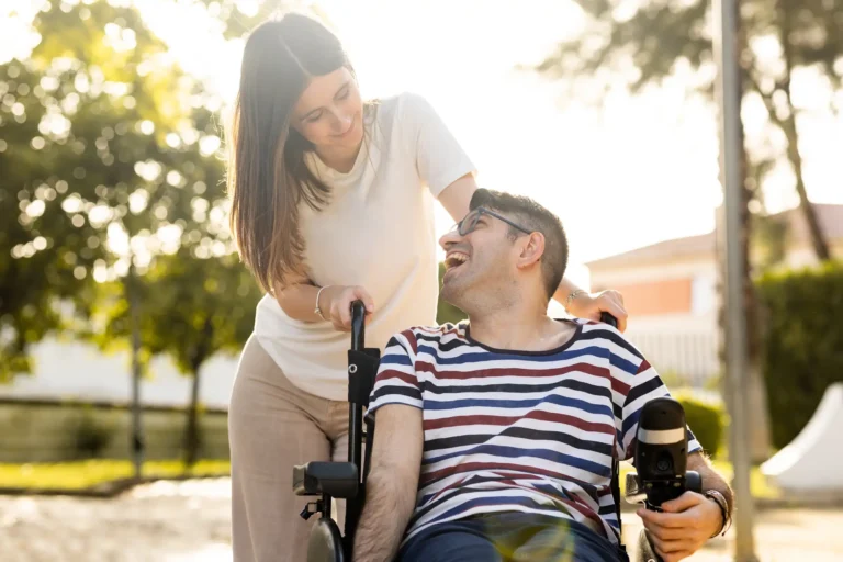 caregiver with individual in wheelchair