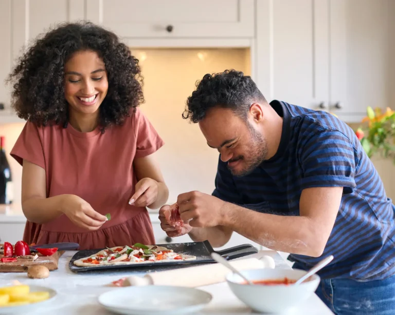 two people cooking together