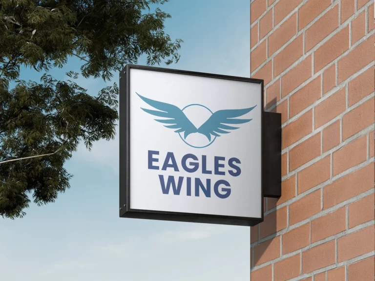 Eagles Wing sign outside on brick wall