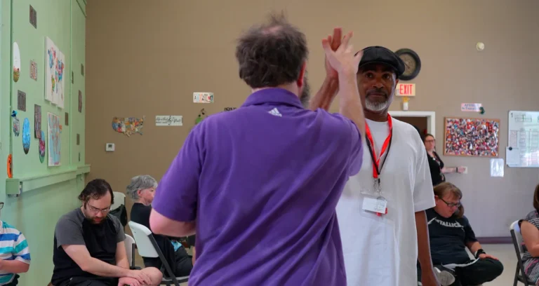 caretaker giving individual a hi five