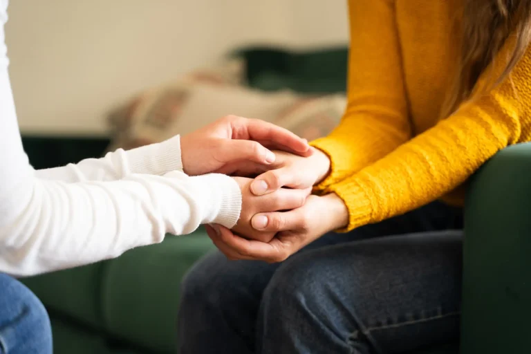 close up of two people holding hands