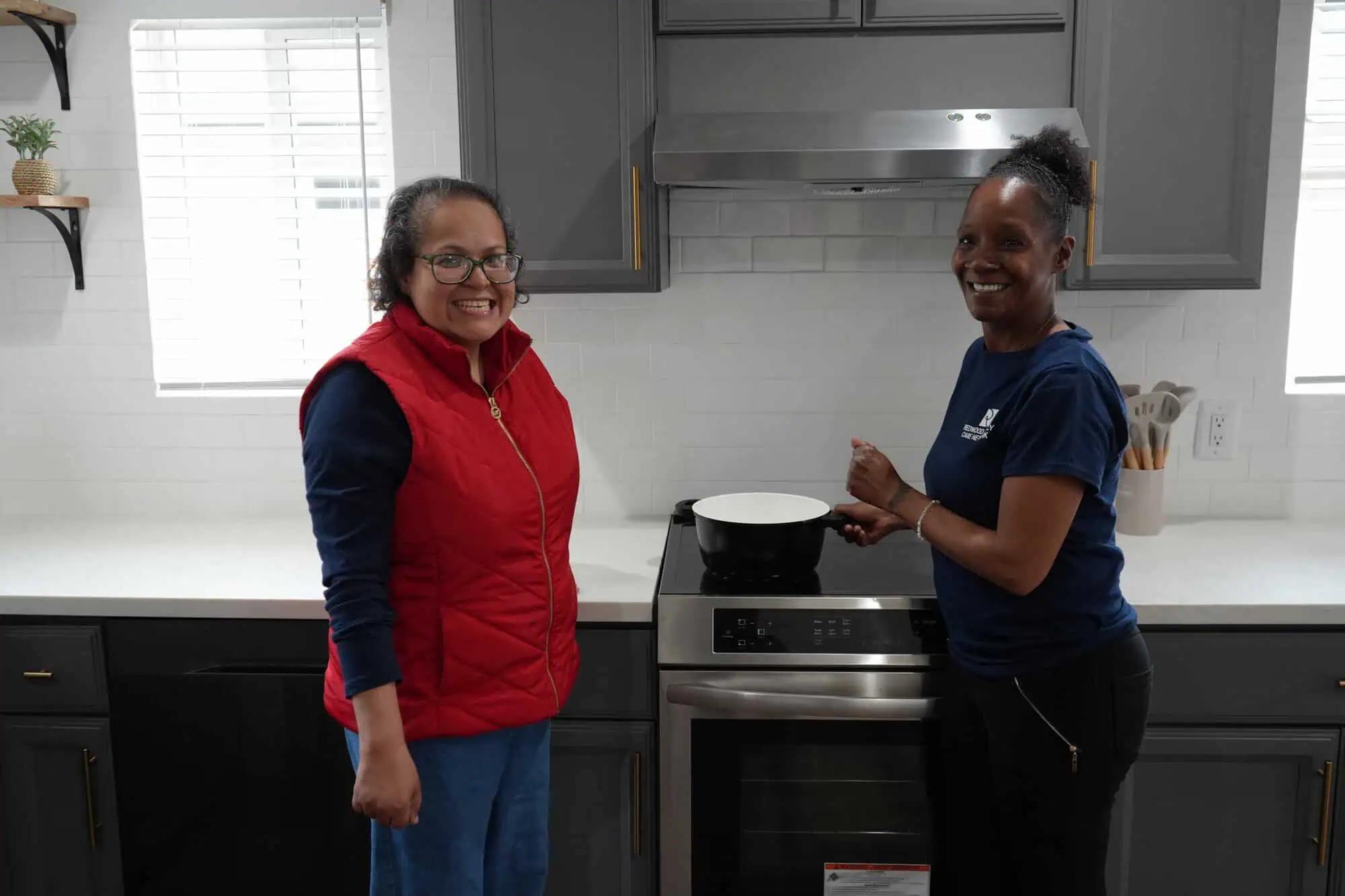 Two women standing in a kitchen