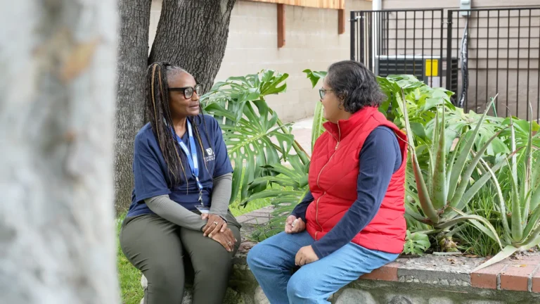 caregiver with individual outside talking