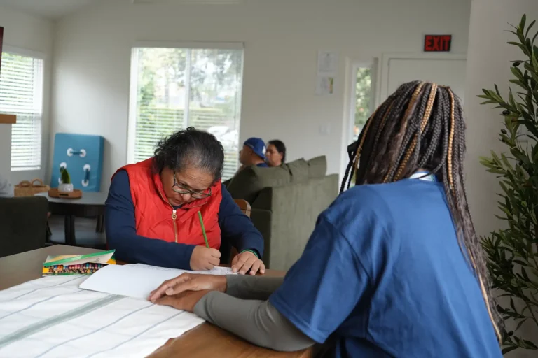 individual writing at a table