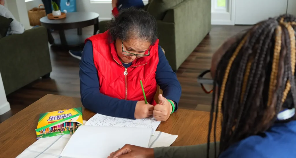 individual writing at a table