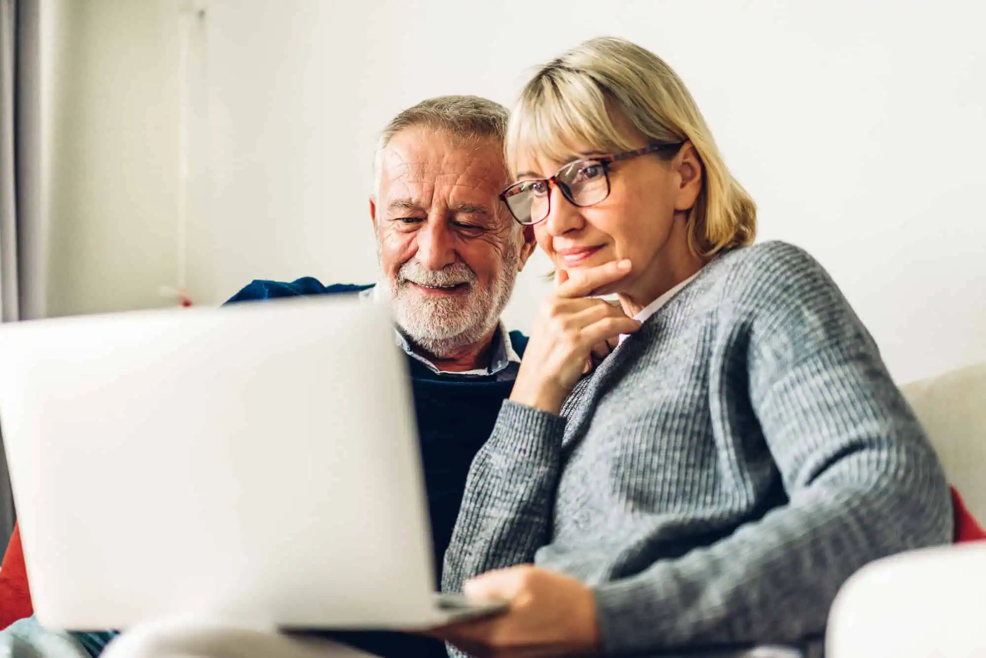 Man and woman looking at a laptop.