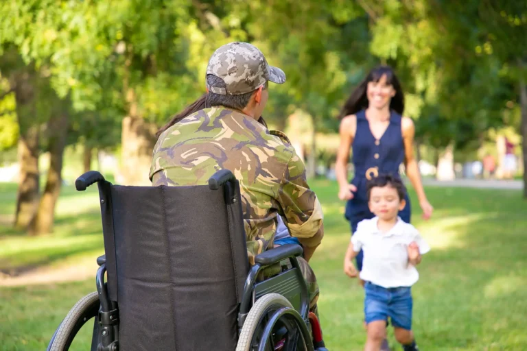 veteran in a wheelchair holding a child