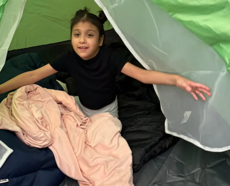 young girl in a tent