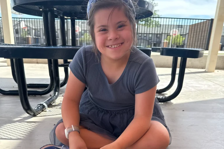 young girl sitting and smiling