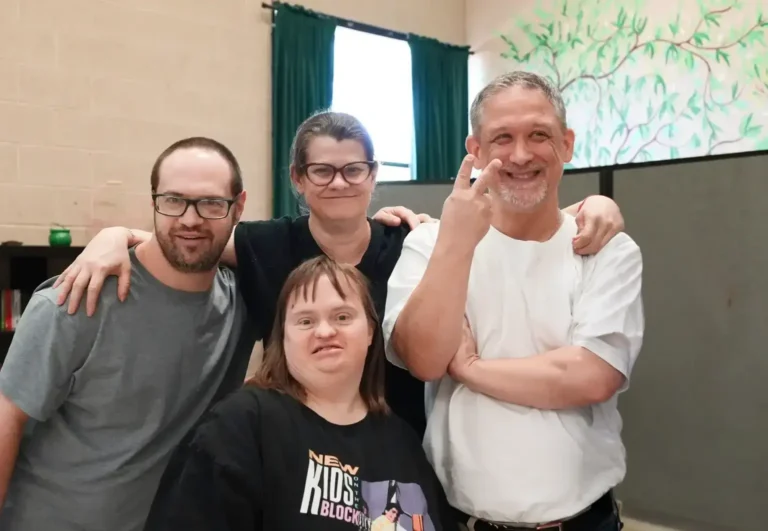 individuals and caretaker smiling